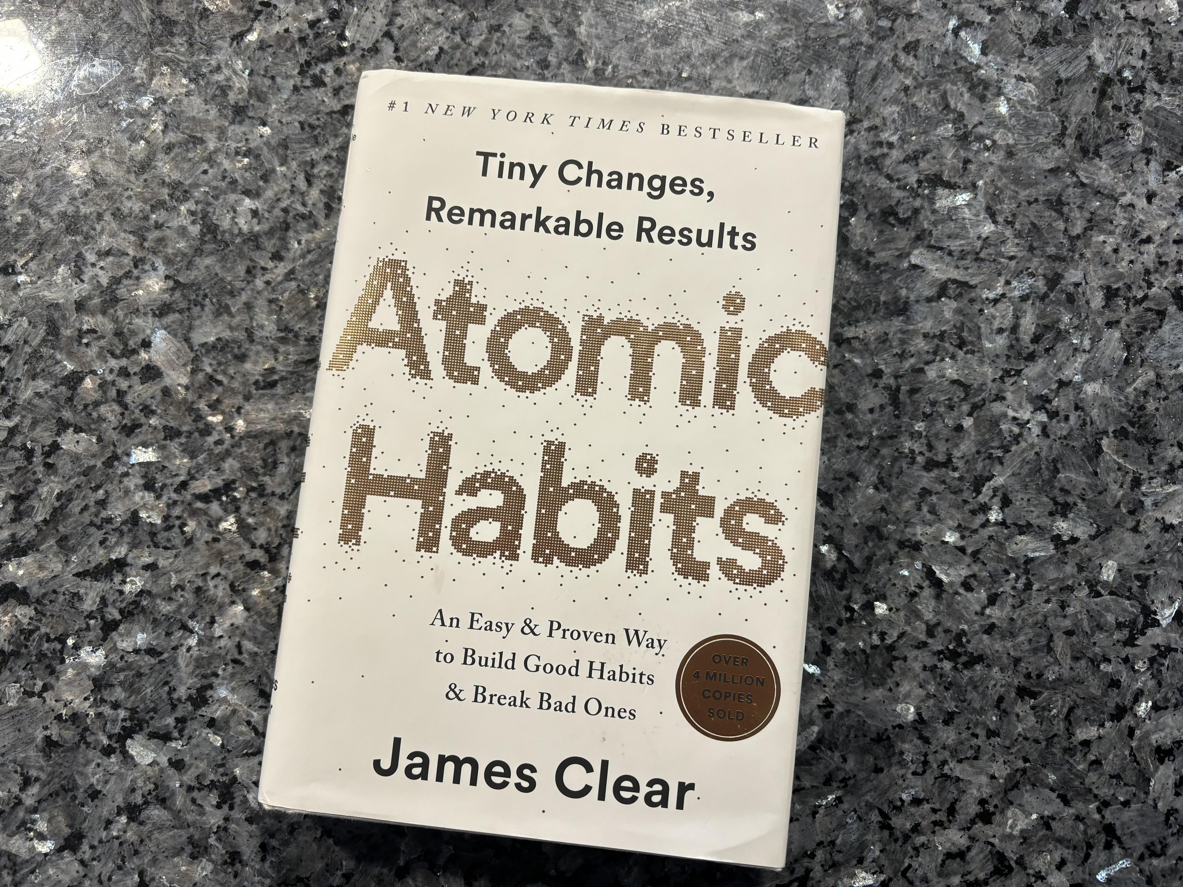 Atomic Habits book sitting on a countertop