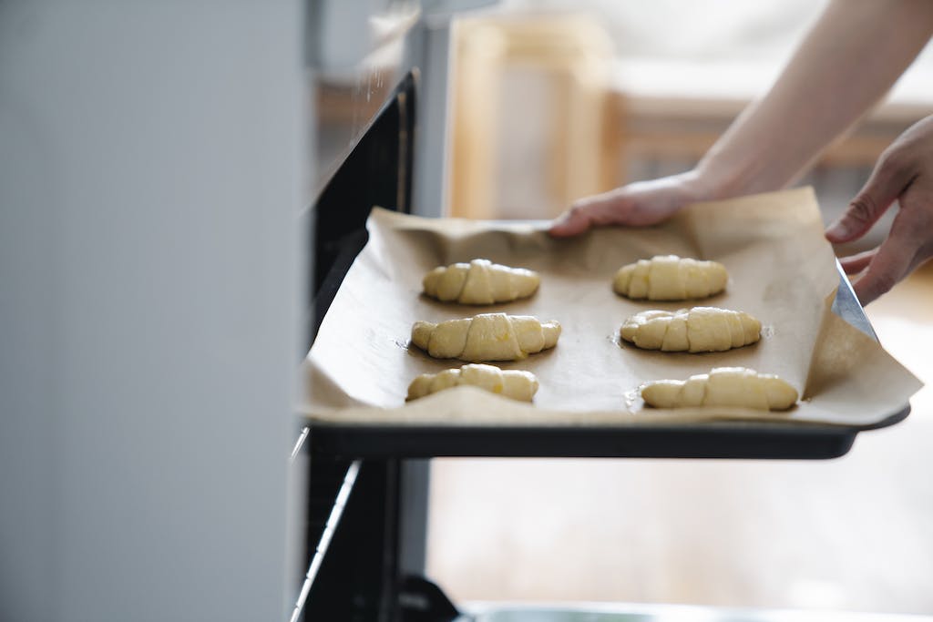 Close-Up Shot of a Person Holding a Baking Tray