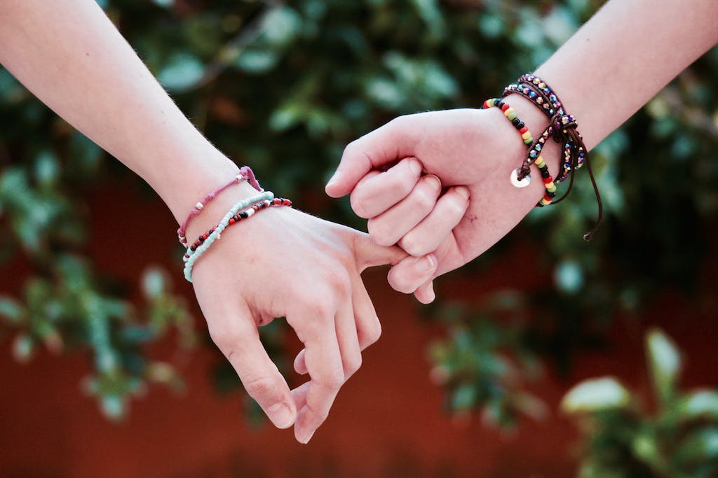 Two Person Holding Hands - friendship as an adult